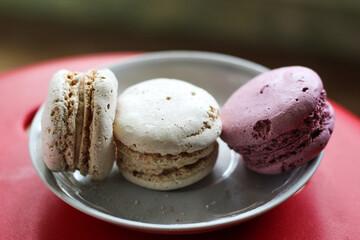 isolated white and pink macaroons on a plate