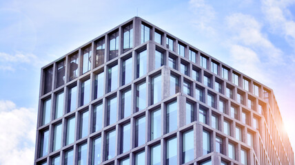 Abstract image of looking up at modern glass and concrete building. Architectural exterior detail of office building. Industrial art and detail. Sunrise.