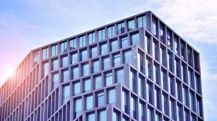 Fototapeta na wymiar Abstract image of looking up at modern glass and concrete building. Architectural exterior detail of office building. Industrial art and detail. Sunrise.