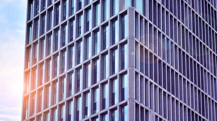 Fototapeta na wymiar Abstract image of looking up at modern glass and concrete building. Architectural exterior detail of office building. Industrial art and detail. Sunrise.