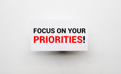 Text focus on your priorities on note paper