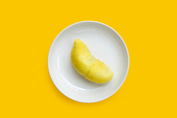Durian in white plate on yellow background.