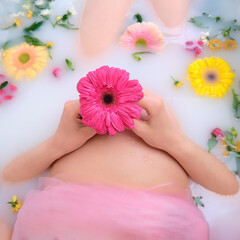 Obraz na płótnie Canvas Pregnant woman belly in white bathroom with flowers