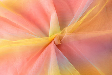 Colorful rainbow organza fabric texture background. Yellow pink blue backdrop