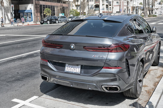 Long Beach, California USA - April 11, 2021: black bmw x6m competition luxury car. back side view