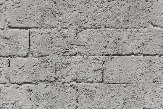 Gray abstract background from old concrete blocks. Wall texture of an old barn made of cement blocks.
