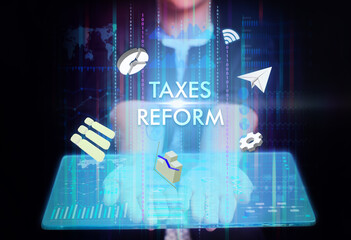 Business, Technology, Internet and network concept. Young businessman working on a virtual screen of the future and sees the inscription: Taxes reform