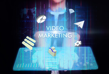 Business, Technology, Internet and network concept. Young businessman working on a virtual screen of the future and sees the inscription: Video marketing
