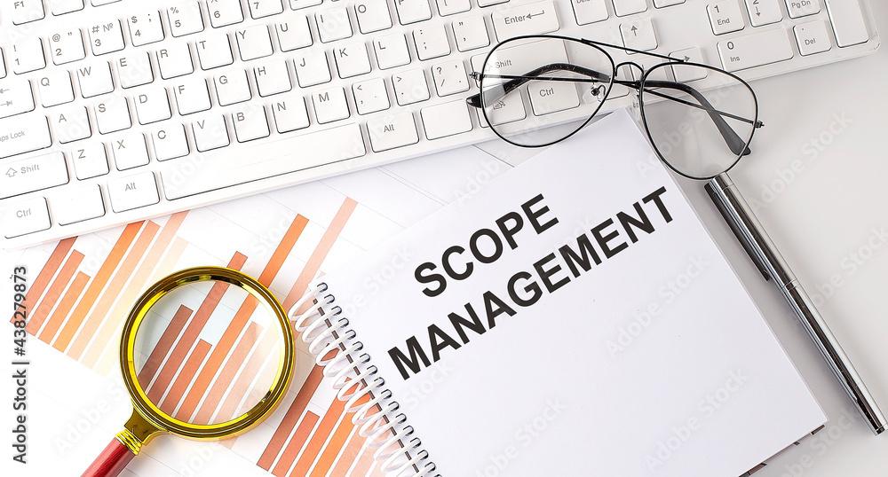 Poster scope management text written on a notebook with keyboard, chart,and glasses