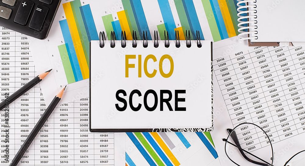 Poster closeup a notebook with text fico score , business concept image on chart background