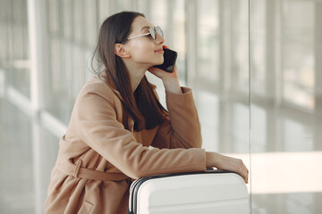 Fototapeta premium Woman with suitcase at the airport