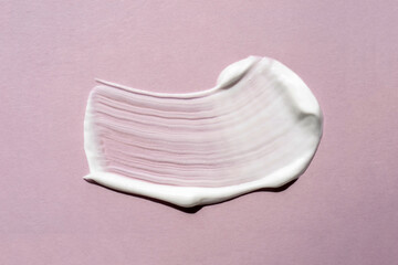 White cream texture on a lilac background.