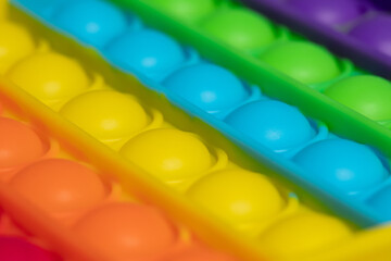 Close-up colorful push to pop it toy. Rainbow color toy. 