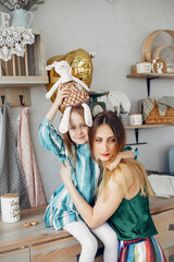 Mother with little daughter in a room