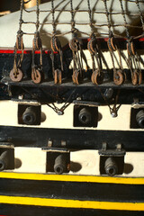 Part of a model warship with guns and a deck.