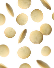 Many lentils falling on white background. Vegan diet