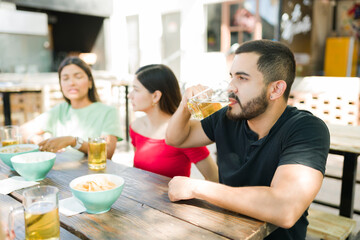 Handsome man meeting some friends at the bar