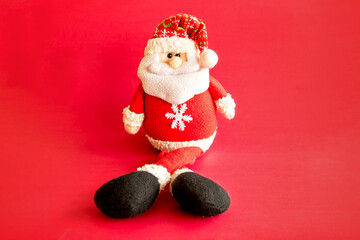 Christmas decoration. Santa Claus doll on red background.