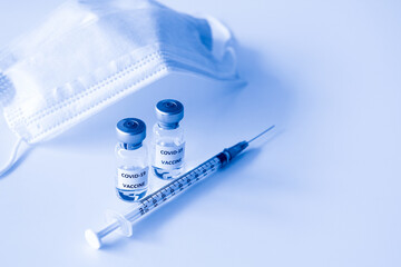 Covid-19 Prevention concept : vial of Covid-19 vaccine, 1 ml plastic syringe with needle and mask