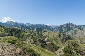 Mountains and grasslands along G217 highway in Xinjiang, China in summer