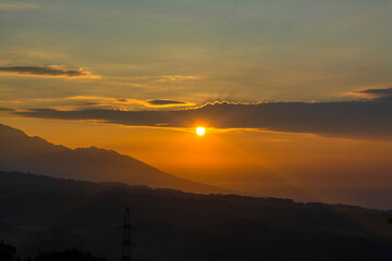 Fototapeta na wymiar Sunrise over beautiful mountains in Indonesia. Majestic sunrise over the mountains