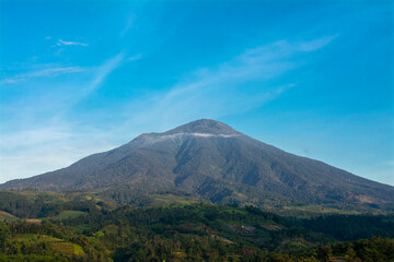 Fototapeta premium Scenic view of mountain under blue sky. Mountain range with visible silhouettes through the sunny day