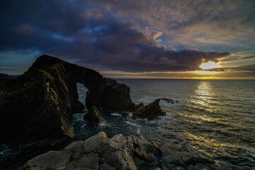 Stac A Phris sea stack arch at sunset, located on the isle of Lewis, Outer Hebrides, Scotland.