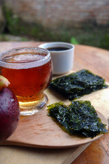 Photo of chopped seaweed and a cup of coffee and mangosteen beside it, a photo of the meaning of the drink