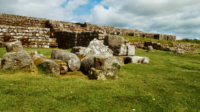 Walking the ruins of Housesteads Roman Fort on Hadrian's Wall, built by the Romans in AD 124 in Northumberland, England, UK. Hadrian's Wall is a UNESCO World Heritage Site