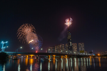 Multiple Colorful fireworks at Ho Chi Minh City celebrating Happy New Year 2020 moments. View from Sai Gon riverside