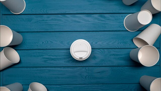 ZERO WASTE: One reusable mug and a many paper cups on a blue table, Top view, Stop motion