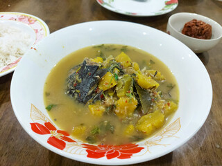 Yellow pumpkin curry in a bowl is a traditional dish of Thai cuisine.