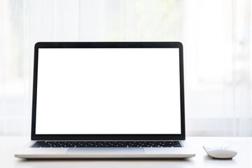 Laptop or computer notebook with blank white screen on white table with mouse. Home interior or office background. Front view.