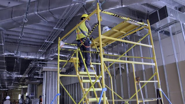 construction site workers working on scaffolding