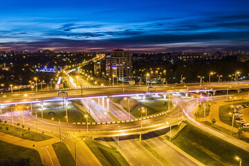 aerial drone photo of urban multilevel ring junction road in twilight time. long exposure.