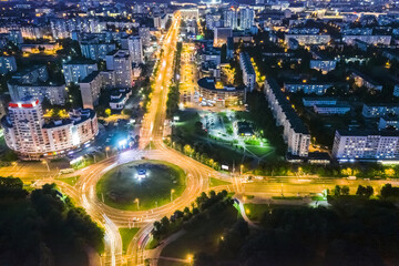 car traffic in night city. aerial view of highway intersection with long exposure