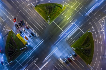 aerial view of busy road intersection. car traffic with light trails on the road at night city.