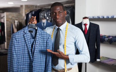 Fashion designer is creating business image in men's store. High quality photo