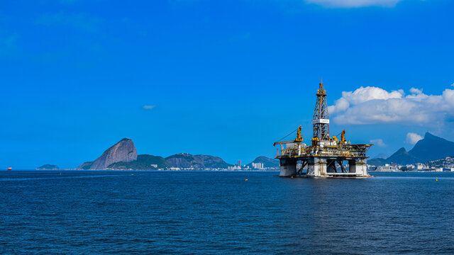 Guanabara Bay, Rio de Janeiro, Brazil - CIRCA 2021: Platform for exploration of the oil industry in Guanabara Bay, in front of Sugarloaf Mountain.