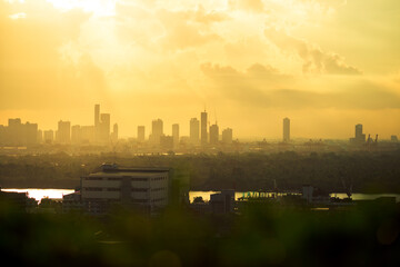 Highly blurred background from the residence,with a panoramic view of the city(condominium,office,home offices,houses,football fields,bridges across the river) and colorful colors from the evening sky