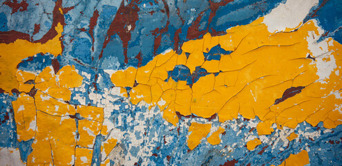 Yellow, blue, white, brown abstract vintage background. Old peeling paint on the wood surface, weathered texture.