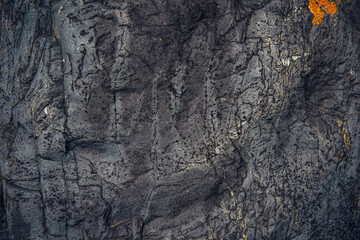 Abstract stone background. Rough surface of gray rock with cracks and natural pattern, close up. Texture for design.