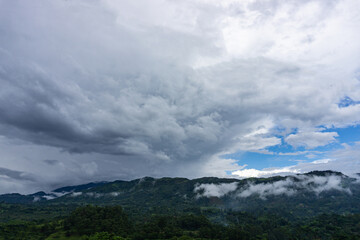 Obraz na płótnie Canvas gray clouds and blue sky over dar the mountains