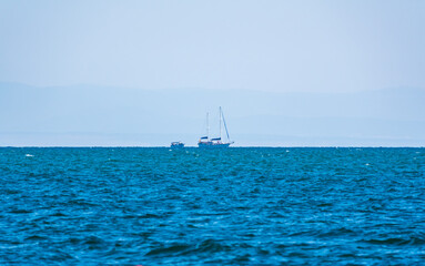 Sailing yacht in the blue calm sea.