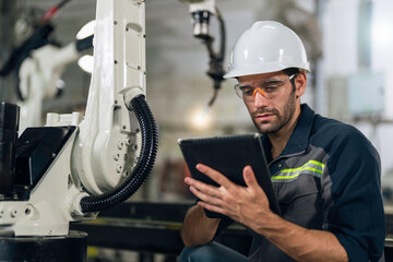 Mechanical engineer doing maintenance the robotic welding machine.