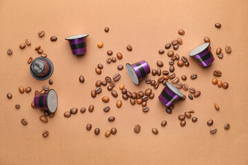 Coffee capsules with beans on color background