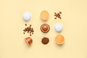 Coffee capsules with beans and powder on color background