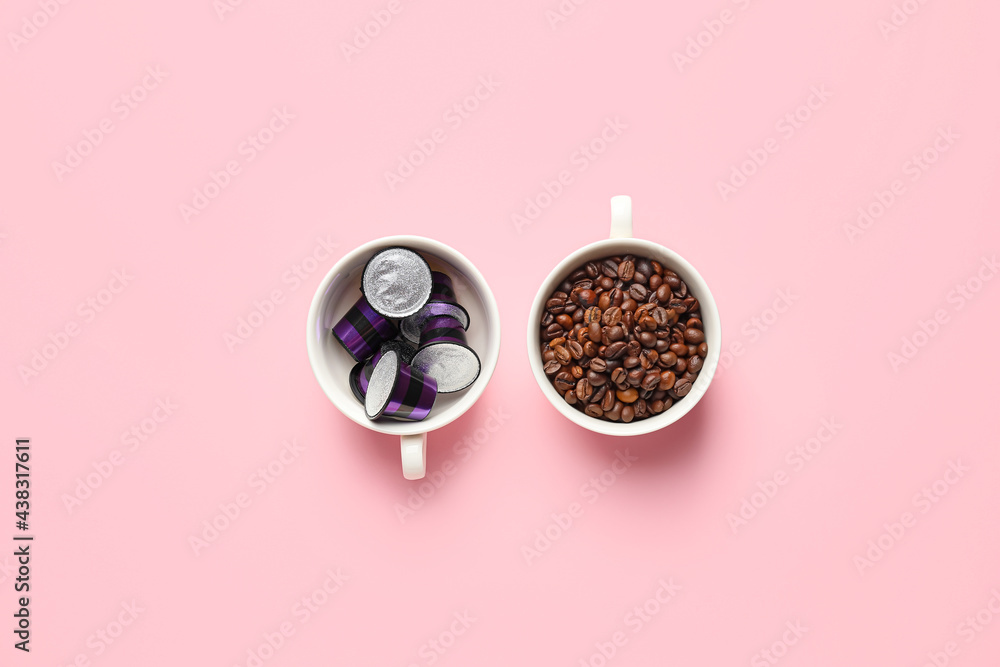 Wall mural cups with coffee capsules and beans on color background