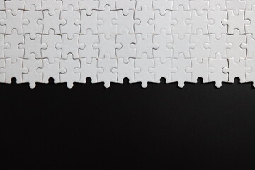 plain black background with white jigsaw puzzle for your content.