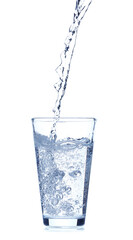 Pouring of water into glass on white background